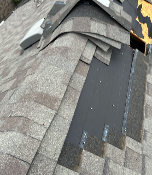 A wide-angle roof photo shows partially stripped shingles near a ridge, exposed OSB decking with torn underlayment, and visible metal step flashing secured with screws.